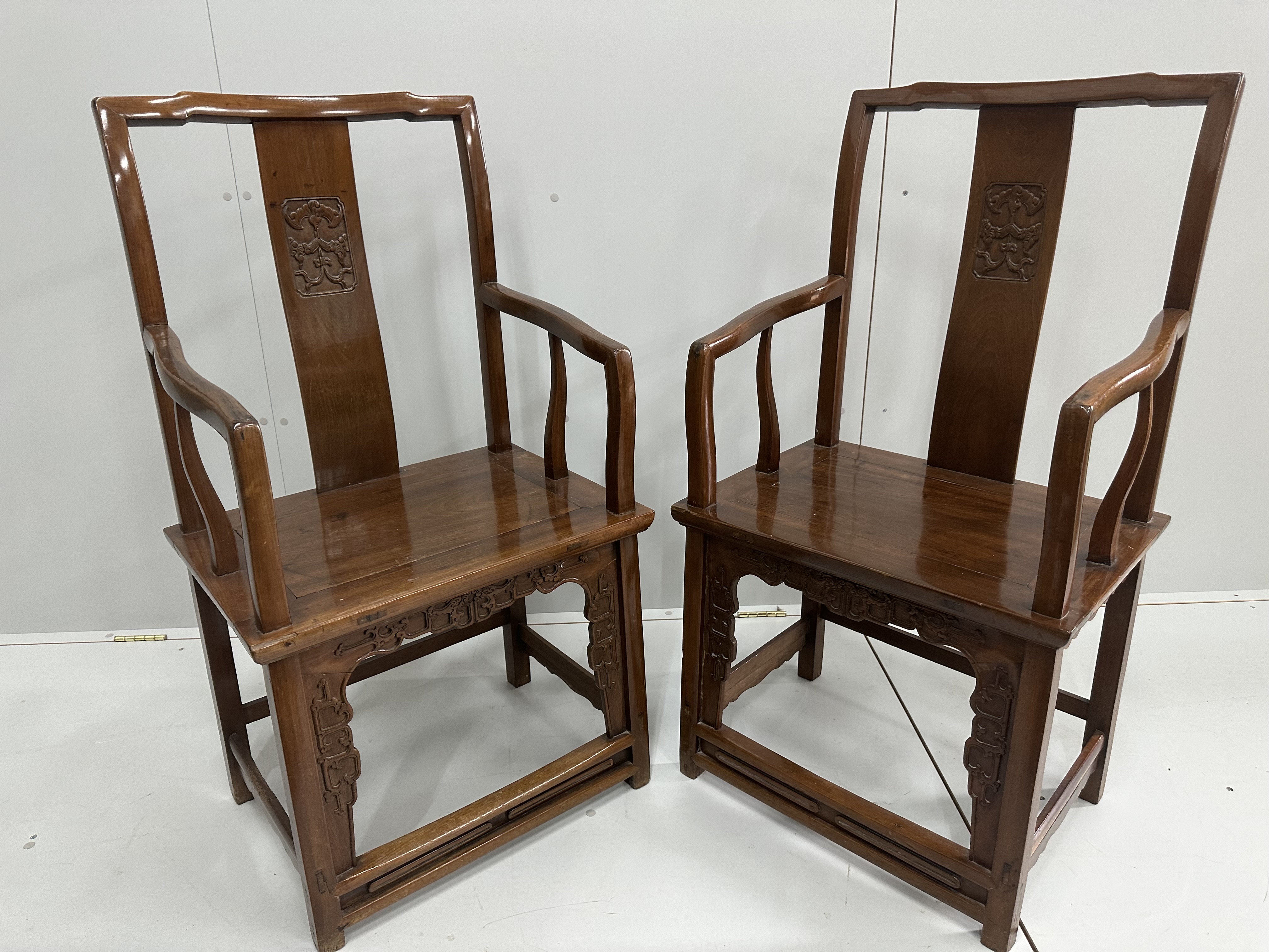 A pair of Chinese hardwood elbow chairs, width 56cm, depth 44cm, height 107cm